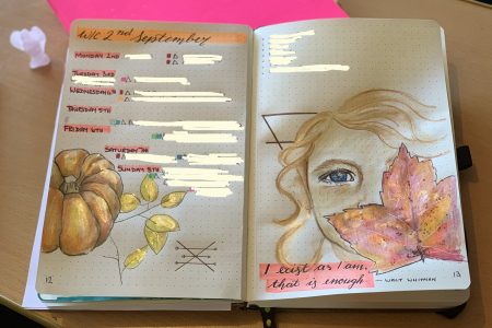Journal with weekly plan and drawing - a pumpkin ad a girl with face obscured by leaf